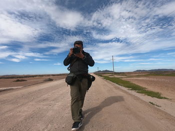 Man photographing on road