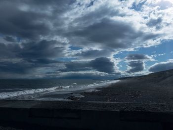 Scenic view of sea against storm clouds