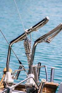 Close-up of sailboat by sea against sky