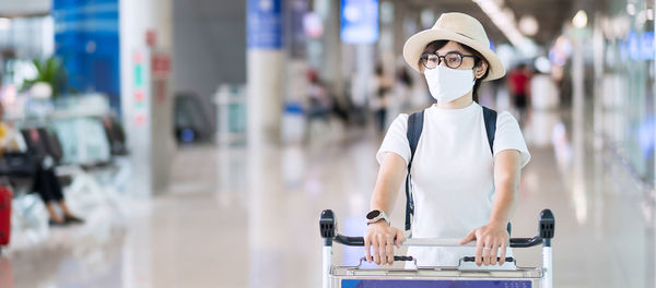 Beautiful woman with mask in airport