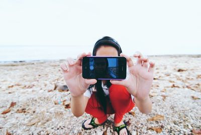 Photographer photographing on beach