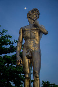 Low angle view of statue against clear blue sky