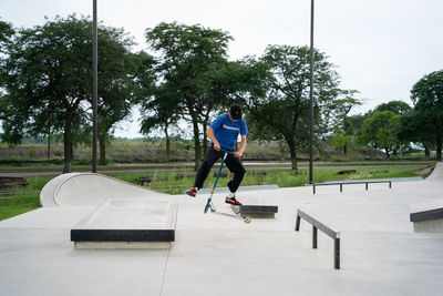 Full length of man skateboarding on skateboard park