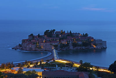 High angle view of illuminated city at waterfront