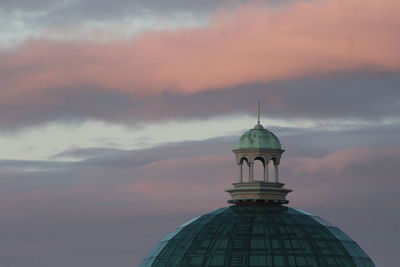 Low angle view of building against cloudy sky