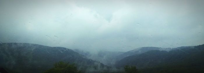 Scenic view of mountains against sky during rainy season