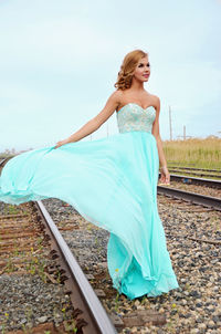 Full length of woman standing on railroad track