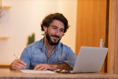 Young business man working with laptop. gray notebook for working. home office . 