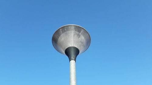 Low angle view of lamp against clear blue sky