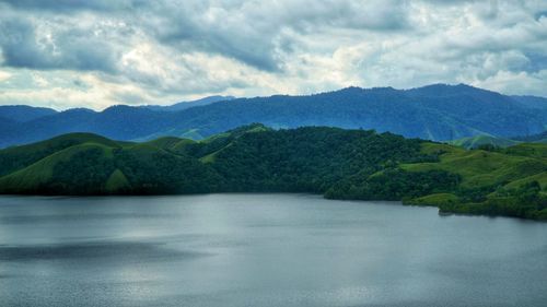 Scenic view of lake and mountains against sky