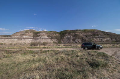 Car on field against sky