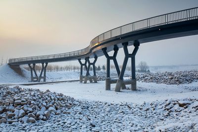 Bridge over river during winter