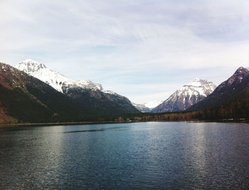 Scenic view of lake and snowcapped mountains against sky