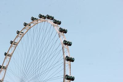 Low angle view of ferris wheel against clear sky