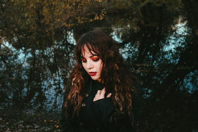 Portrait of young woman standing outdoors