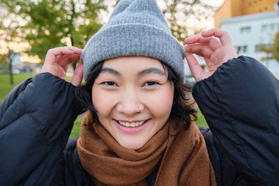 Portrait of young woman wearing hat