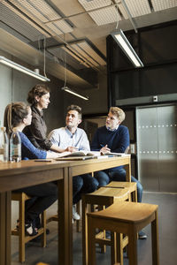 Low angle view of professor and students in classroom