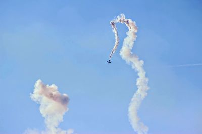 Low angle view of airplane flying in sky