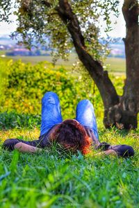 Low section of woman lying on grass