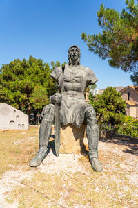 Statue against clear blue sky