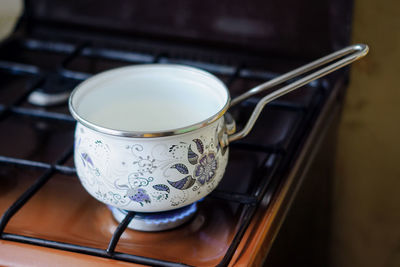 Small pan of milk on a gas stove