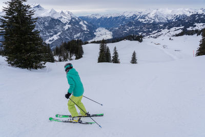 Full length of man skiing on snowcapped mountain