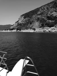 Boat sailing on sea against clear sky