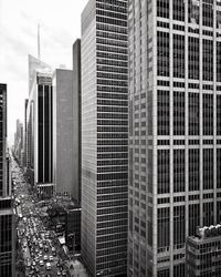 Traffic on street by skyscrapers in manhattan