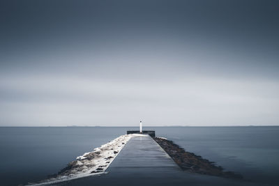 Pier over sea against clear sky