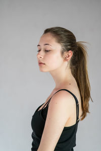 Portrait of a young woman against white background