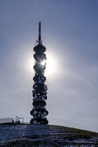 Italy, kronplatz mountain communications tower standing against shining sun