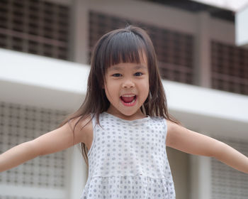 Portrait of cute girl standing outdoors