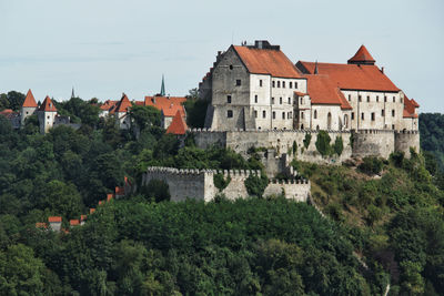 Buildings in town against sky