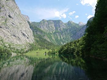 Scenic view of lake and mountains against sky