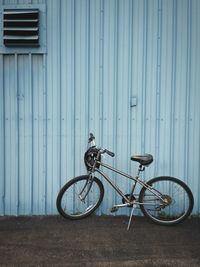 Bicycle parked against wall