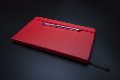 High angle view of pen on table against black background