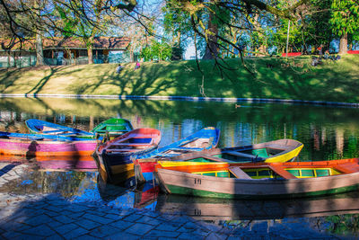 Multi colored boats in lake at park
