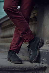 Low section of man relaxing on staircase