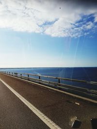 Road by sea against sky