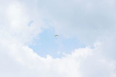 Low angle view of bird flying against sky