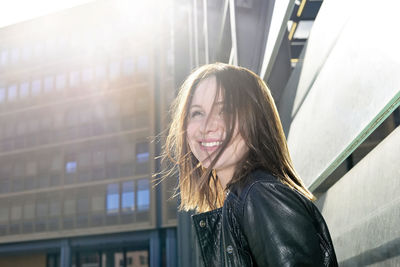 Smiling young woman in city