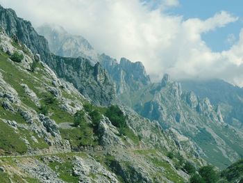 Scenic view of mountains against cloudy sky