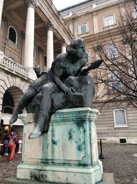 Statue against sky in city