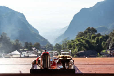 View of drink on table against mountains