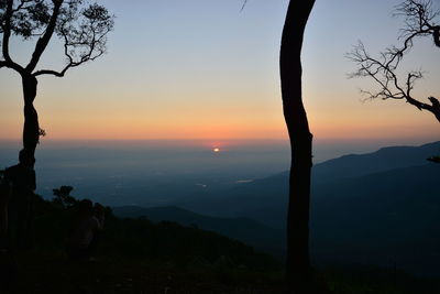 Scenic view of silhouette mountains against sky at sunset