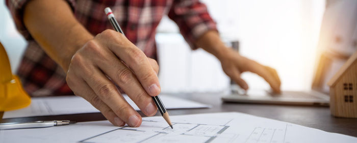 Midsection of man working on table