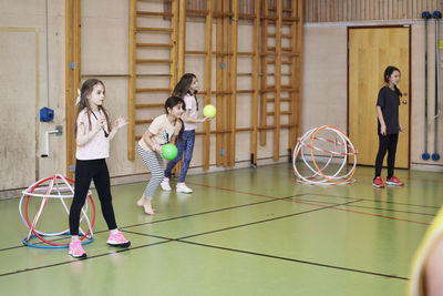 Children having pe class in school gym