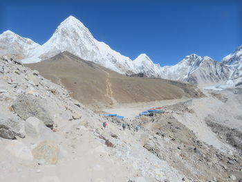 Scenic view of snowcapped mountains against clear blue sky