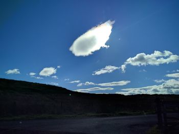 Scenic view of vapor trail against blue sky