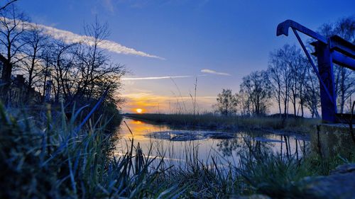 Scenic view of lake against sky during sunset